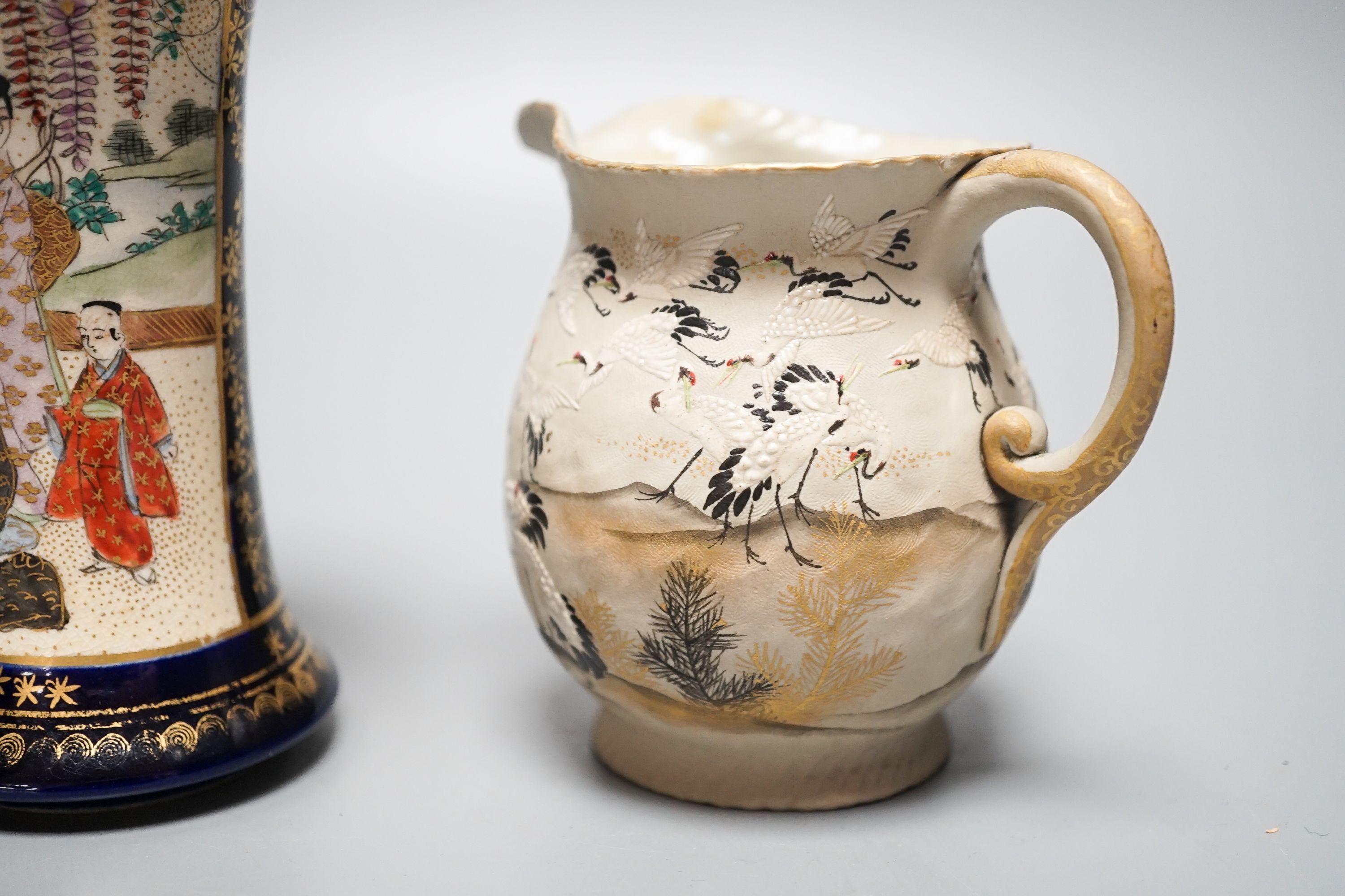 A Japanese black ground ‘cranes’ cloisonné enamel vase, 18.3cm, a Satsuma pottery vase and a crane decorated jug (3)